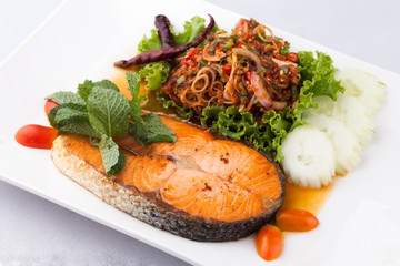 fried salmon fish with spicy salad