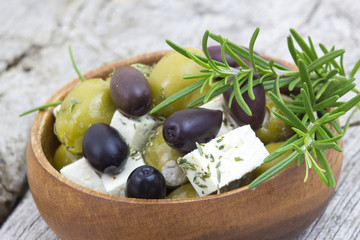 feta cheese and olives with herbs in olive oil