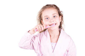 Beautiful happy smiling little girl brushing her teeth