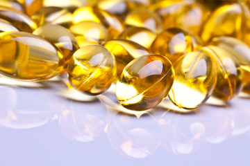 Cod liver oil omega 3 gel capsules isolated on pastel background