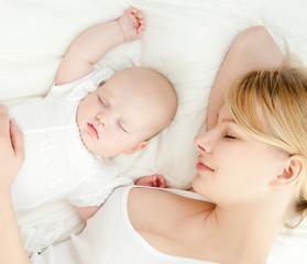 Young mother and her baby, sleeping in bed