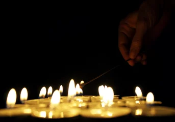 Foto auf Acrylglas Hand lighting a candle © vali_111