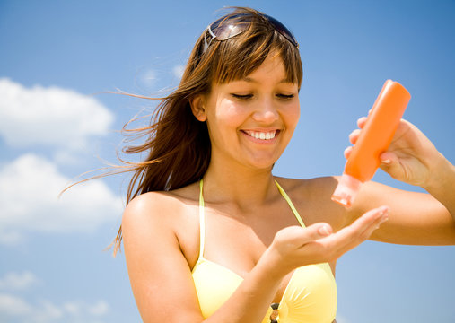 woman in bikini  smear protective cream