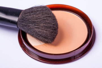 close up of a  make-up accessories -powder, eyeshadow,lipstick