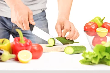 Fotobehang Male cutting cucumber, preparing salad © Ljupco Smokovski