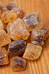 brown caramelized sugar on wooden background