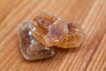 brown caramelized sugar on wooden background