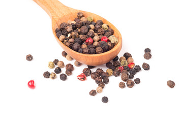 Pepper in a wooden spoon isolated on a white background