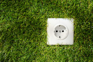 Outdoor electrical socket in green grass