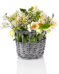 Bouquet of flowers in basket isolated on white
