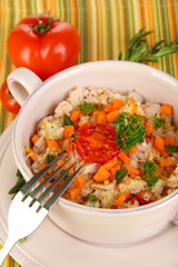 Delicious rice with vegetables and herbs in pot