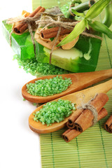 Hand-made soap and sea salt on bamboo mat, isolated on white