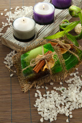 Hand-made soap and sea salt  on grey bamboo mat