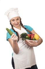 girl teenager in cap of the cook with cucumber and vegetables