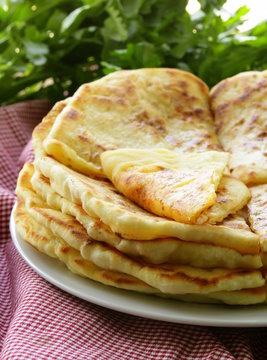 pile of fried bread with butter and parsley
