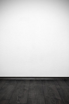 blank white wall and wooden floor