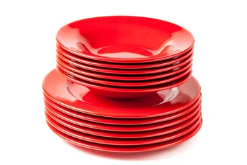 Gordijnen Stack of colorful red ceramics plates on white background © Deymos.HR