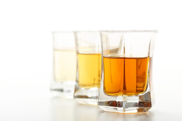 shot tre bicchieri con tequila su sfondo bianco