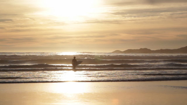 Surfer at sunset. Tofino, BC.