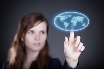 Woman's hand pushing world map button, touch screen
