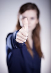 Woman's hand, thumbs up finger