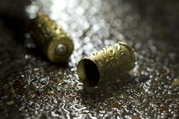 Bullets on ground on rainy day