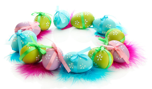 Wreath of bright easter eggs and decorative feathers, isolated