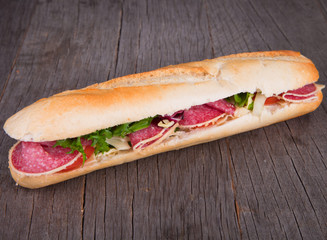 Fresh French healthy baguette on wood 