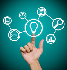 Hand pointing to business icons