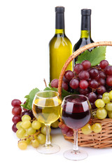 bottles and glasses of wine and grapes in basket, isolated