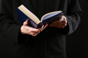 Priest reading from the holy bible, close up