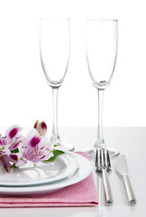 Festive table setting with flowers isolated on white
