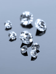 Beautiful shining crystals (diamonds), on grey background