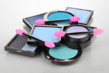 Bright eye shadows and sponge brushes for foundation
