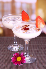 Fruit smoothies on table on window background