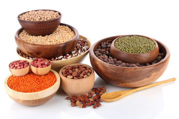 Different kinds of beans in bowls isolated on white