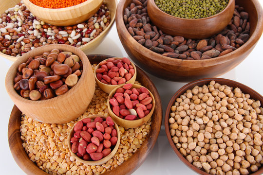 Different kinds of beans in bowls close-up