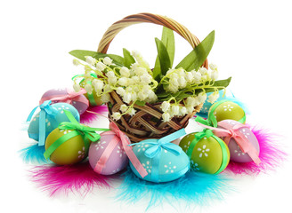 Beautiful easter eggs and lilies of the valley in basket ,