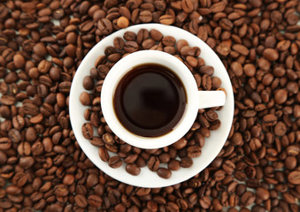 Cup of coffee on coffee beans background