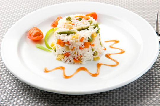 Delicious risotto with vegetables on table