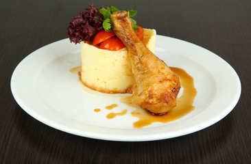 Small portion of food on big plate on wooden table