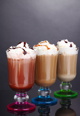 Layered coffee in glass on table on grey background