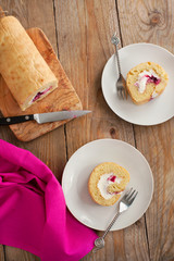 Swiss roll with whipped cream and black currant jam