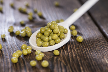 Peas on a wooden spoon