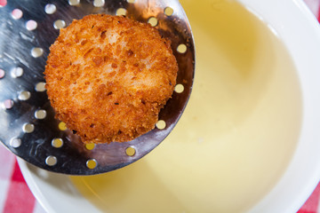 Kiev chicken on  perforated spoon