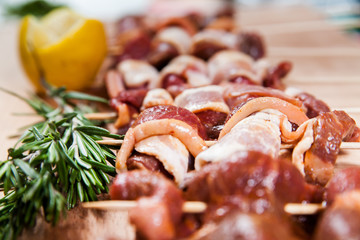 Meat rolls with bacon on stick