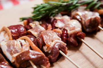 Meat rolls with bacon on stick