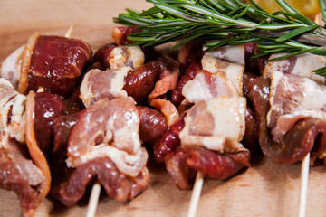 Meat rolls with bacon on stick