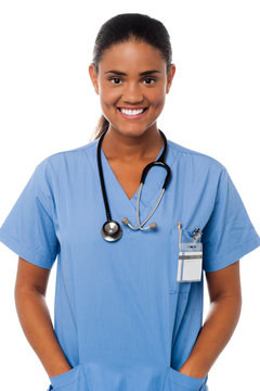 Young female doctor with hands in pocket