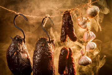 Ham, sausage and garlic in a homemade smokehouse - obrazy, fototapety, plakaty